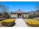 View of the community clubhouse with landscaped grounds and pedestrian access at 307 Montgomery Way, Woodstock, GA 30188