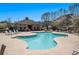 Community pool with lounge chairs and clubhouse in the background at 307 Montgomery Way, Woodstock, GA 30188