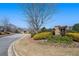 Entrance to Cornerstone Estates community with a stone sign surrounded by landscaping at 307 Montgomery Way, Woodstock, GA 30188