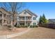 Charming home with a second-story porch, manicured front yard, and a welcoming entrance at 307 Montgomery Way, Woodstock, GA 30188