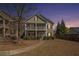 Evening exterior of a charming home with a second-story porch and manicured front yard at 307 Montgomery Way, Woodstock, GA 30188