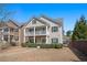 Charming two-story home with a cozy front porch and well-manicured landscaping on a bright day at 307 Montgomery Way, Woodstock, GA 30188