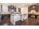 Stylish kitchen with dark cabinets, stainless appliances, island with bookshelf, and adjacent office space at 307 Montgomery Way, Woodstock, GA 30188