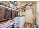 Organized laundry room with white washer/dryer, wood-look vinyl flooring, and plenty of shelf space for storage at 307 Montgomery Way, Woodstock, GA 30188