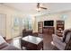 Comfortable living room with hardwood floors, a ceiling fan, and natural light streaming through the windows at 307 Montgomery Way, Woodstock, GA 30188