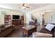 Spacious living room featuring hardwood floors, a ceiling fan, and a staircase leading to the upper level at 307 Montgomery Way, Woodstock, GA 30188