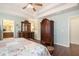Spacious bedroom with trey ceiling and plenty of windows, featuring a full suite of furniture and hardwood flooring at 307 Montgomery Way, Woodstock, GA 30188