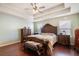 Comfortable main bedroom with trey ceiling, ceiling fan, and dark wood furnishings at 307 Montgomery Way, Woodstock, GA 30188