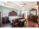 Spacious bedroom with trey ceiling and plenty of windows, featuring a full suite of furniture and hardwood flooring at 307 Montgomery Way, Woodstock, GA 30188