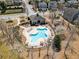A community pool area with lounge chairs, tables, and landscaped surroundings, perfect for relaxation and social gatherings at 307 Montgomery Way, Woodstock, GA 30188