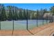 Fenced tennis court for residents offers a great recreational amenity and gathering spot for friendly competition at 307 Montgomery Way, Woodstock, GA 30188