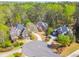Aerial view of elegant homes with brick facades, manicured lawns, and circular driveways in a well-landscaped neighborhood at 3816 Berrybridge Se Way, Marietta, GA 30067