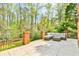 A beautifully hardscaped porch features ample seating and an abundance of surrounding trees at 3816 Berrybridge Se Way, Marietta, GA 30067