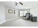 Neutral bedroom features plush carpet, ceiling fan, and a computer desk setup, perfect for study or work at 3816 Berrybridge Se Way, Marietta, GA 30067