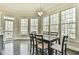 Sun-filled breakfast nook featuring a modern chandelier, hardwood floors and large windows with wooded views at 3816 Berrybridge Se Way, Marietta, GA 30067