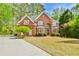 Traditional brick home with well-manicured lawn and mature landscaping, offering great curb appeal at 3816 Berrybridge Se Way, Marietta, GA 30067