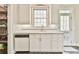 A spacious kitchen has a white color scheme and a door to an outdoor balcony at 3816 Berrybridge Se Way, Marietta, GA 30067
