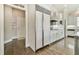 Bright kitchen has stainless appliances, oversized white cabinetry, and hardwood floors at 3816 Berrybridge Se Way, Marietta, GA 30067