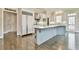 A modern kitchen features white cabinets, stainless steel appliances, and a center island at 3816 Berrybridge Se Way, Marietta, GA 30067