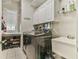 Bright laundry room with washer, dryer, sink, white cabinets and shelving for storage at 3816 Berrybridge Se Way, Marietta, GA 30067