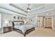 Comfortable main bedroom featuring tray ceilings, plush carpet, and a ceiling fan at 3816 Berrybridge Se Way, Marietta, GA 30067