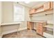 Home office boasts built-in cabinets, drawers, workspace, and tiled floors for a functional setup at 3816 Berrybridge Se Way, Marietta, GA 30067