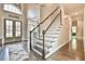 Elegant staircase with white spindles and wooden handrail leading to the upper level at 3816 Berrybridge Se Way, Marietta, GA 30067