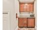 Home wet bar features custom wood cabinets, granite countertops, beverage fridge, and vintage popcorn maker at 3816 Berrybridge Se Way, Marietta, GA 30067