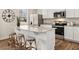 Kitchen with stainless steel appliances, granite countertops and kitchen island with barstool seating at 102 Hill Side Ln, Dallas, GA 30157