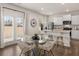 Open-concept kitchen and dining area with a glass table and seating for four at 102 Hill Side Ln, Dallas, GA 30157
