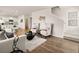 Open-concept living room features hardwood floors, modern decor and comfortable seating at 102 Hill Side Ln, Dallas, GA 30157