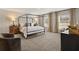 Spacious main bedroom featuring a four-post bed, soft carpet, and bright windows at 102 Hill Side Ln, Dallas, GA 30157