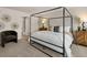 Stylish main bedroom featuring a four-poster bed, soft carpet, and a chair at 102 Hill Side Ln, Dallas, GA 30157
