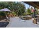 The backyard features a gorgeous stone hot tub, fireplace with seating, and lovely landscaping at 12800 Wyngate Trl, Alpharetta, GA 30005