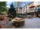 Backyard featuring a stone fire pit with built in benches and a partial view of the elevated deck at 12800 Wyngate Trl, Alpharetta, GA 30005