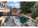 Outdoor living space with an in-ground spa, stone bar, and dining area, great for entertaining guests at 12800 Wyngate Trl, Alpharetta, GA 30005