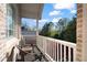 Cozy balcony featuring two chairs and beautiful brick and siding details at 12800 Wyngate Trl, Alpharetta, GA 30005