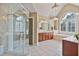 This bathroom has a glass enclosed shower and a jacuzzi soaking tub in a modern spacious design at 12800 Wyngate Trl, Alpharetta, GA 30005