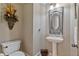 Cozy half-bath with pedestal sink and decorative mirror at 12800 Wyngate Trl, Alpharetta, GA 30005