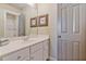 Bright bathroom with a shower, white vanity, chrome faucet, and decorative butterfly artwork at 12800 Wyngate Trl, Alpharetta, GA 30005
