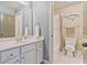 Bathroom featuring a vanity, mirror, and shower with a dolphin wall decoration at 12800 Wyngate Trl, Alpharetta, GA 30005