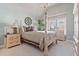 Inviting bedroom showcases natural light, a four-poster bed, and classic furnishings, creating a serene retreat at 12800 Wyngate Trl, Alpharetta, GA 30005