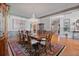 Formal dining room featuring a chandelier, hardwood floors, and a large dining table, perfect for hosting gatherings at 12800 Wyngate Trl, Alpharetta, GA 30005