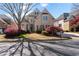 Beautiful two-story brick home with a manicured front lawn and a curved driveway. Classic and elegant design at 12800 Wyngate Trl, Alpharetta, GA 30005