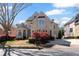 Elegant two-story brick home featuring a manicured lawn, charming bay window, and a symmetrical facade at 12800 Wyngate Trl, Alpharetta, GA 30005