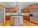 This kitchen features custom wood cabinets, granite countertops, stainless steel appliances, and a kitchen island at 12800 Wyngate Trl, Alpharetta, GA 30005