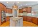 Well-appointed kitchen features stainless steel appliances, granite countertops, and a functional center island at 12800 Wyngate Trl, Alpharetta, GA 30005