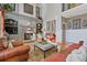 Cozy living room with a stone fireplace, built-in shelves, and comfortable seating at 12800 Wyngate Trl, Alpharetta, GA 30005