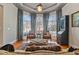 Comfortable living room with large arched windows, plantation shutters, and hardwood floors at 12800 Wyngate Trl, Alpharetta, GA 30005