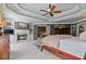 Spacious main bedroom with a fireplace, tray ceiling, and ensuite bathroom with a large closet and plenty of space at 12800 Wyngate Trl, Alpharetta, GA 30005